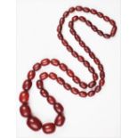A cherry amber bead necklace, the single strand graduated bead necklace