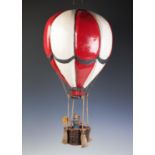 A painted wooden hanging model of a hot air balloon group,