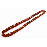 A single strand 'amber' bead necklace, designed as thirty six graduated beads