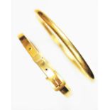 A 9ct yellow gold slave bangle,