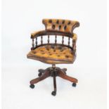 A tan leather revolving captains chair, 20th century,