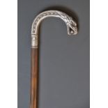 A white metal mounted stained bamboo cane,