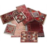 A selection of prayer mats and small rugs,