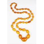 A 'Butterscotch' amber single strand bead necklace,