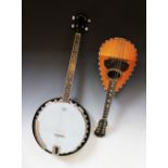A modern four string banjo by Ashbury, with 11" Remo skin and 15.5" fret board,