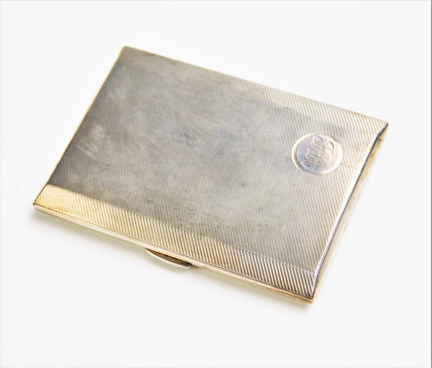 A silver cigarette case,