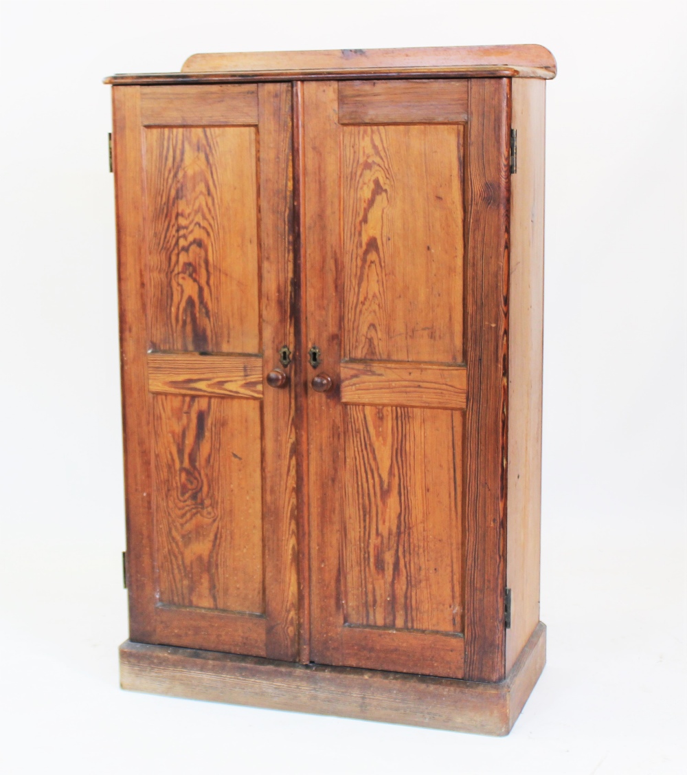 A Victorian pitch pine two door cupboard,