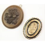 A Victorian mourning brooch, designed as a central aperture enclosing hair,