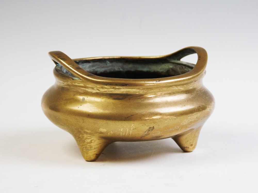 A Chinese polished bronze tripod censer,