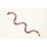 An amethyst line bracelet set in 9ct gold,