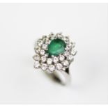 An emerald and diamond set cluster ring