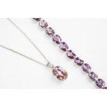 A kunzite and diamond set pendant,