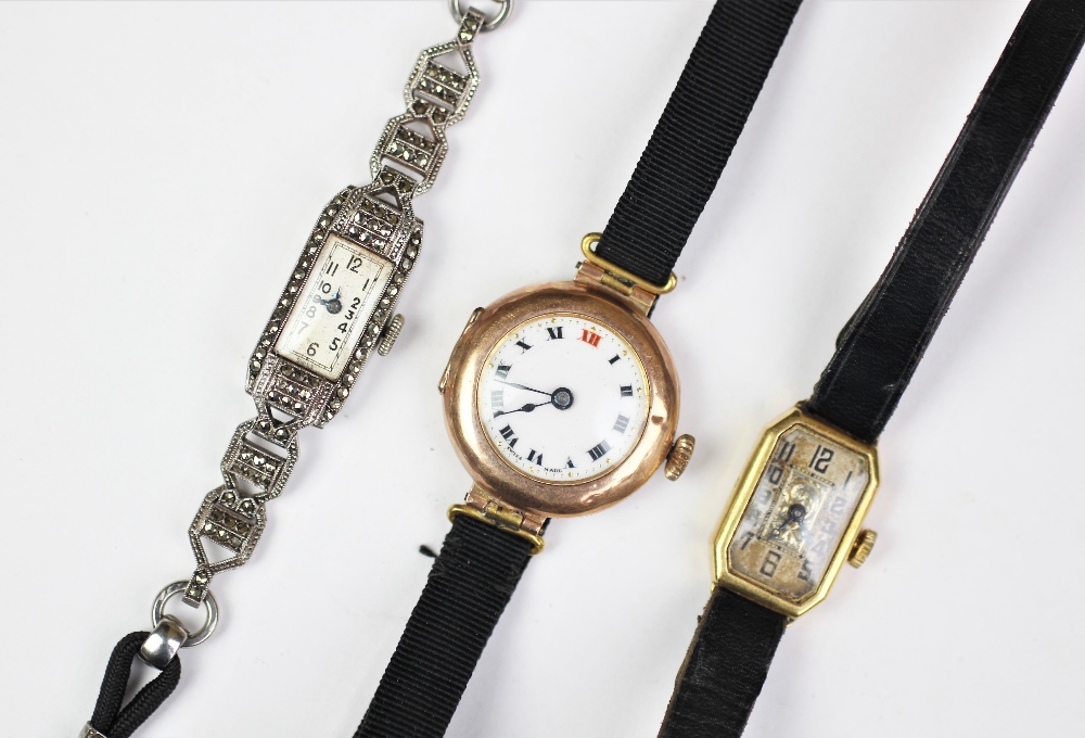 A 9ct gold cased ladies wristwatch with white enamel dial and black roman numerals,