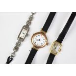 A 9ct gold cased ladies wristwatch with white enamel dial and black roman numerals,