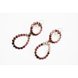 A pair of 19th century garnet set drop earrings, designed as a concentric circle