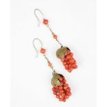 A pair of coral coloured bead set grape and vine leaf drop earrings,
