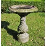 A reconstituted stone bird bath,