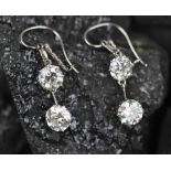 A pair of two stone diamond set drop earrings, each designed as a claw set brilliant cut diamond,