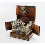 A late 19th/early 20th century amboyna, mother of pearl and brass inlaid liquor set,
