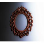 A carved wooden frame in the Black Forest style,