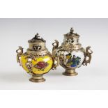 An associated pair of Chinese porcelain white metal mounted koro's and covers,