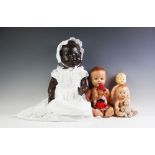 A German composition black doll stamped 'H W', in white cotton gown and bonnet,