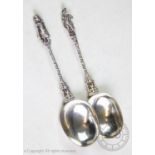 A pair of continental white metal apostle spoons, with oval bowls, chased and rope-twist stems and