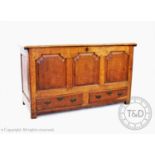 A George III oak mule chest, the rectangular moulded top above three fielded panels and a pair of