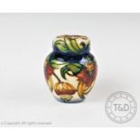 A Moorcroft ginger jar and cover of small proportions, decorated in the 'Anna Lily' design by Nicola