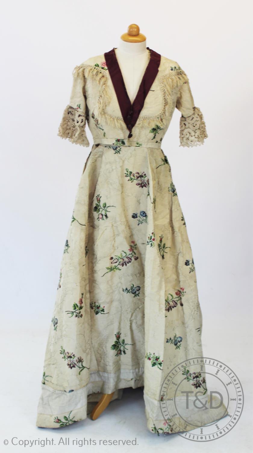A Spitalfield silk dress, circa 1760's, the ivory silk with woven rococo design with sprays of