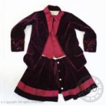 A claret velvet boys? outfit, circa 1880, comprising a jacket, waistcoat and skirt all in one,