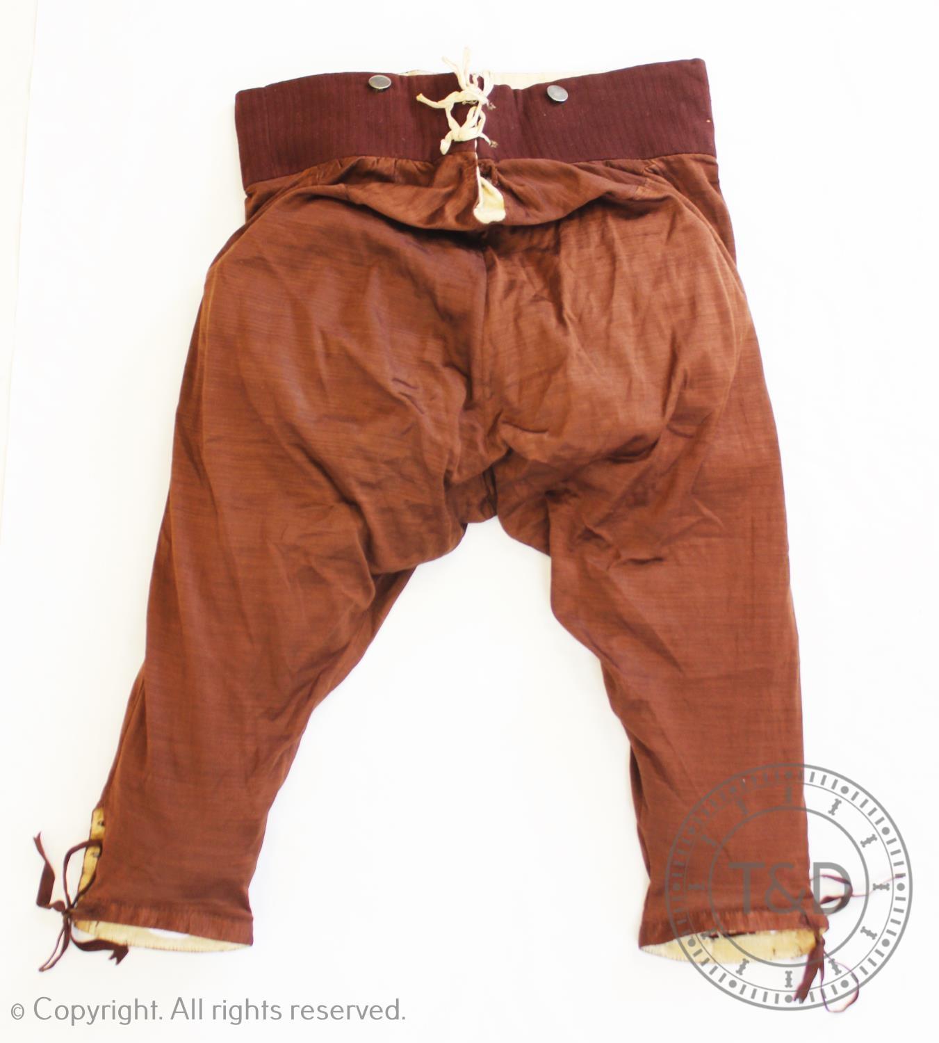 A rare pair of men?s breeches, circa 1820, in brown, with striped woollen waistband, and silk - Image 2 of 2