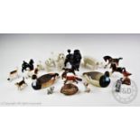 A collection of ceramic animals to include two large and two small Beswick poodles, a Beswick pig, a