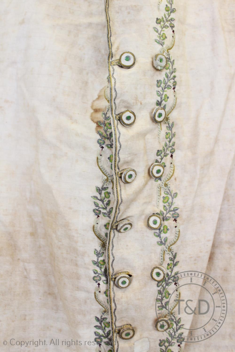 An ivory striped woven cotton waistcoat, circa 1800, the edges decorated with foliate sprays and - Image 7 of 9