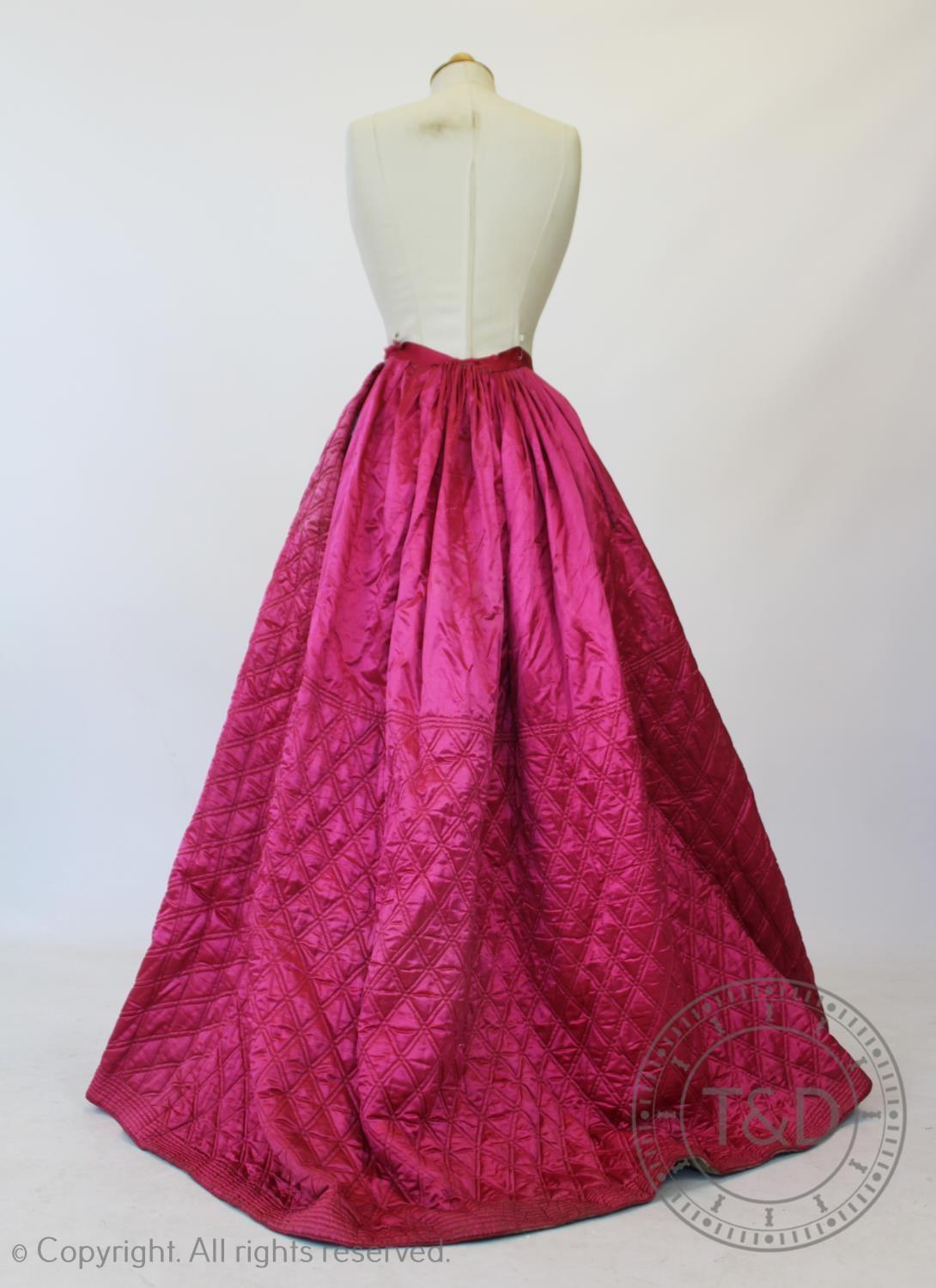 A fuscia silk quilted petticoat, circa 1845, with diamond quilted detail to the front and back and - Image 2 of 4
