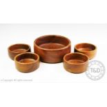 A treen fruit bowl and four smaller bowls, diameters 25cm and 15cm (5)