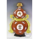 A Chinese porcelain 'Da ji' gourd wall plaque, of typical double-gourd form bound with a ribbon,