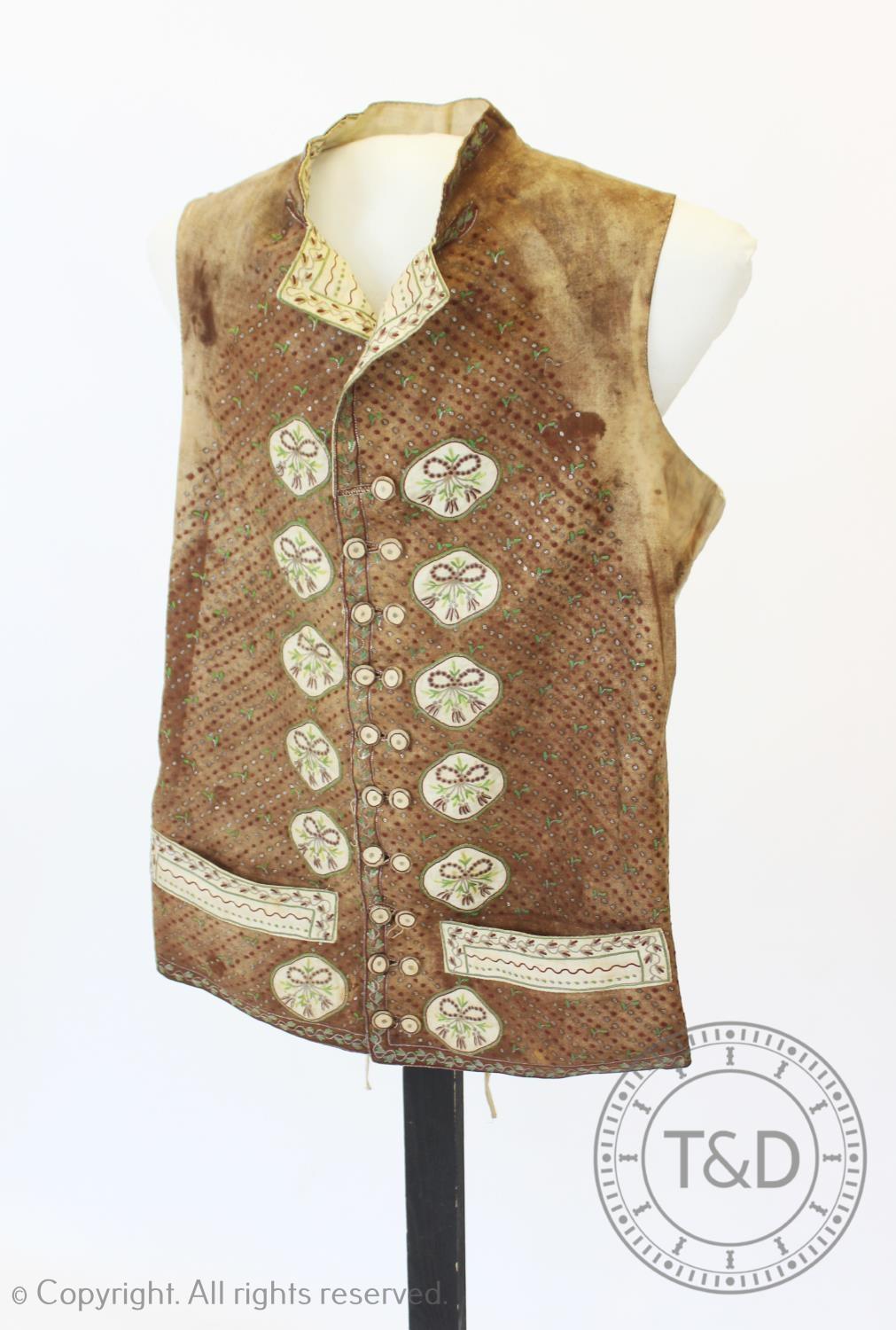 A brown metallic embroidered waistcoat, circa 1800, extensively decorated with metallic crimson