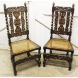 A pair of Victorian Carolean style oak hall chairs , with a pair of acorn shaped finials above a