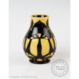 A Moorcroft baluster vase of small proportions, decorated with black trees on a yellow ground, marks