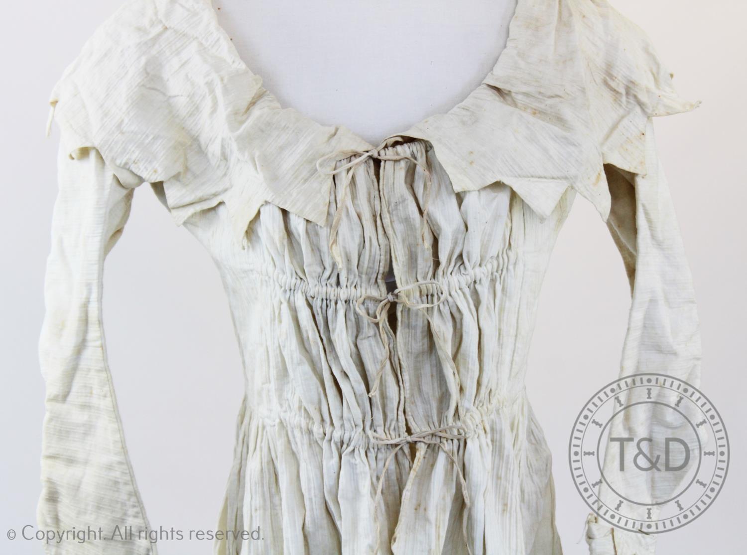 A embossed striped ivory cotton dressing jacket, circa 1795, possibly maternity, the collar and - Image 2 of 2