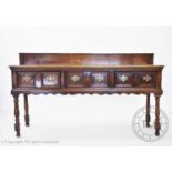 A George III oak Shropshire dresser base, with a reduced dwarf back above a rectangular top and