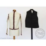 An ivory silk taffeta sleeved waistcoat or jacket, circa 1810, boldly banded and edged in dark plum,