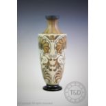 A Martin Brothers stoneware vase of baluster form with tapering neck, the vase with incised