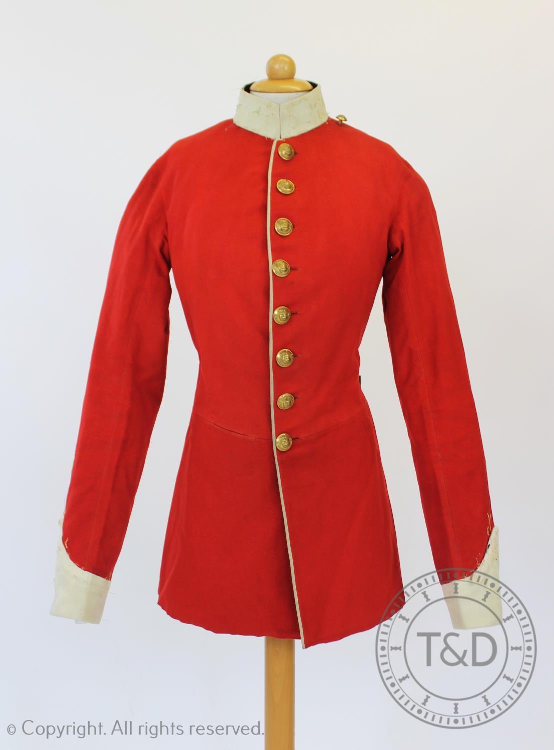 A Lancashire Regiment dress tunic and matched trousers, the scarlet coat with military buttons to