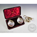 A pair of Victorian silver salts, Atkin Brothers, Sheffield 1896, of shell form, on three ball feet,