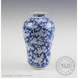 A Chinese porcelain blue and white vase, of bulbous form and decorated with extensive blooms, 20.5cm