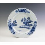 A large 18th century Chinese blue and white charger, centrally decorated with rocky outcrops and