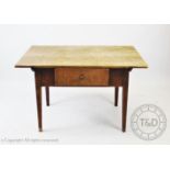 A George III rustic sycamore kitchen table, the rectangular scrub plank top above a single frieze