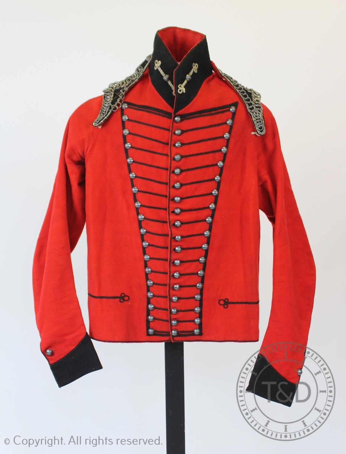 An early 20th century Cheshire Cavalry jacket and associated trousers, the jacket with navy braiding